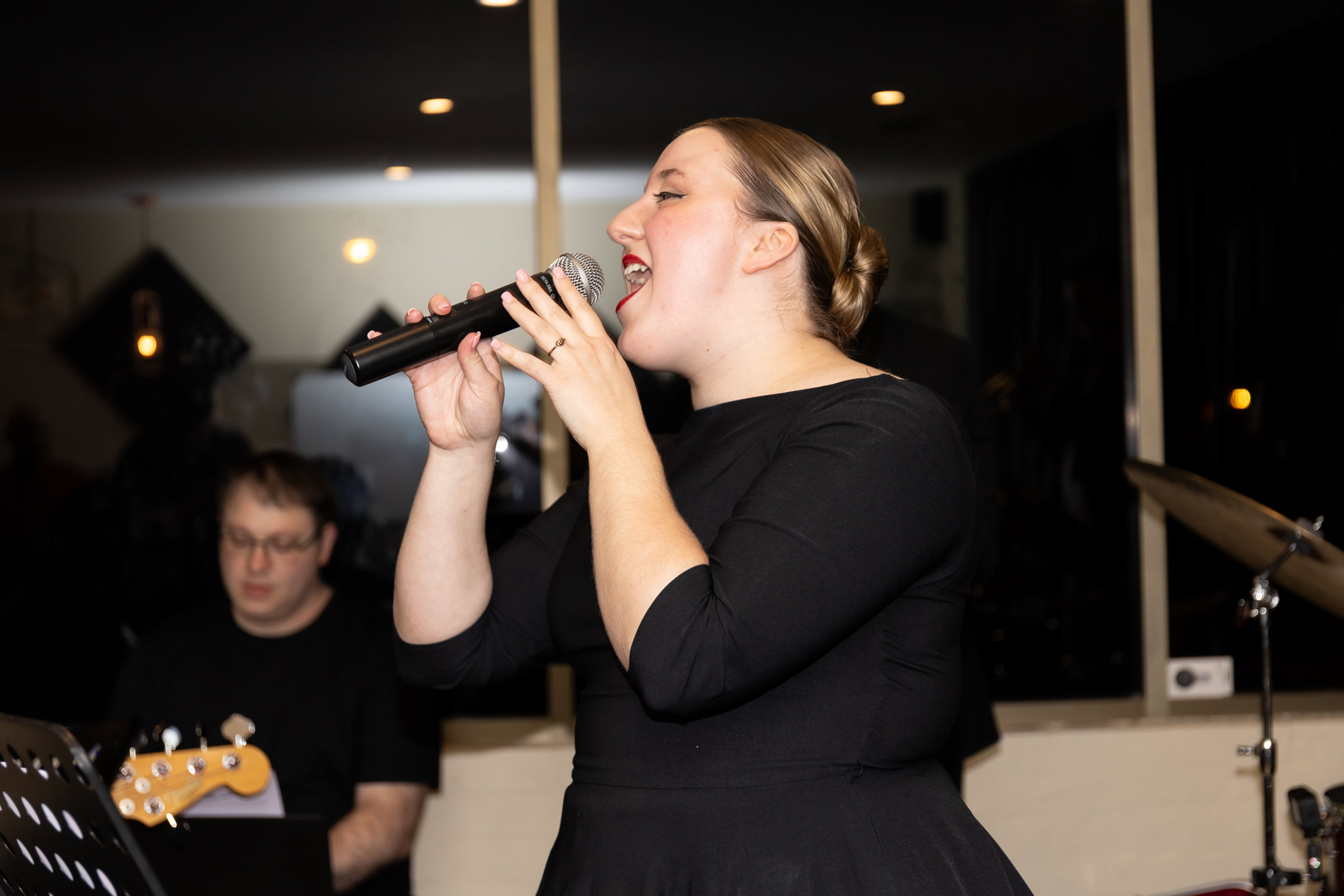 Gilbert Ernest leads Swing The Boogie on a glowing ballroom stage.